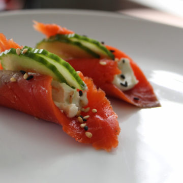 Smoked salmon rolled with cream cheese, cucumber, sesame seeds