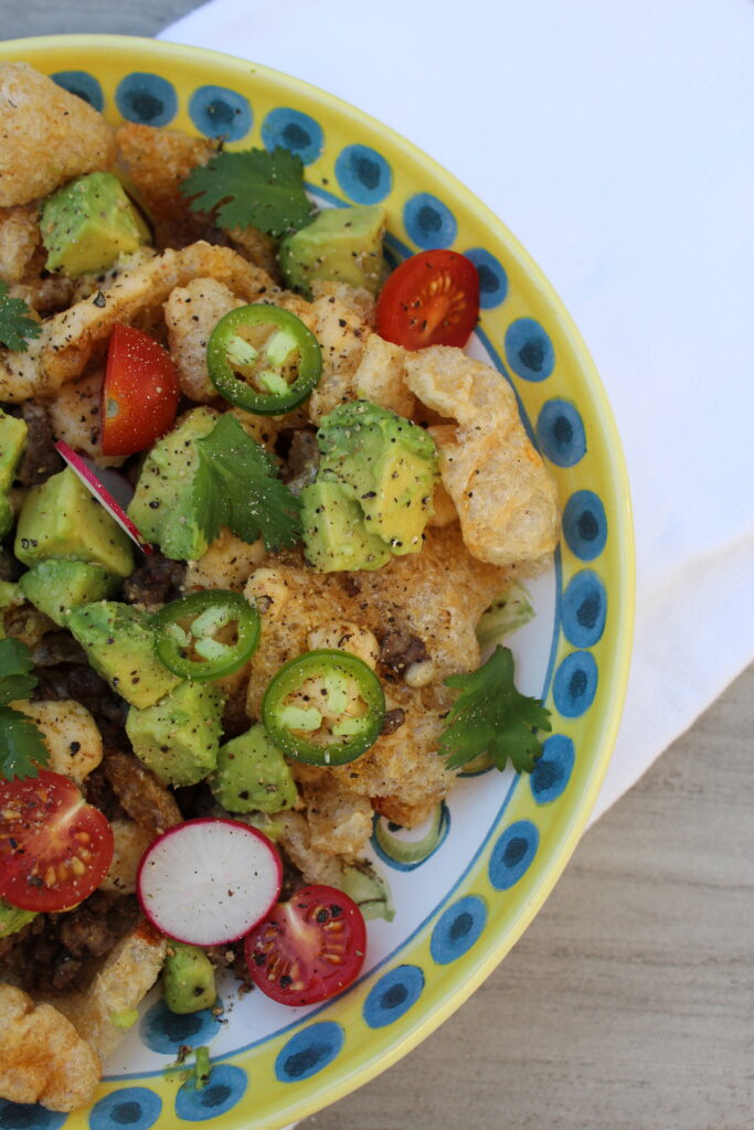 Close up photo of plate with pork rinds nachos with ground beef